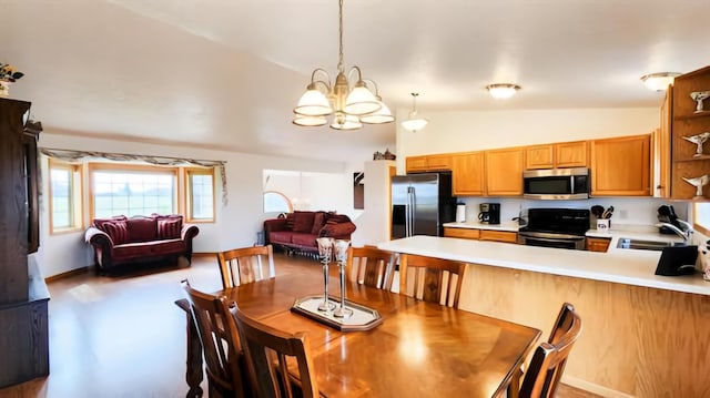 dining room with sink, lofted ceiling, and a notable chandelier