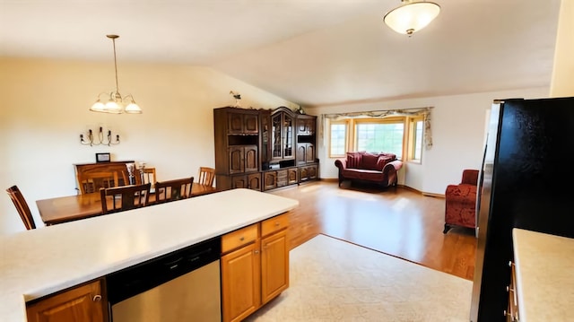 kitchen featuring dishwasher, a notable chandelier, refrigerator, vaulted ceiling, and light wood-type flooring