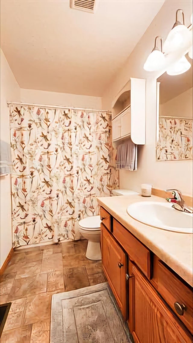 bathroom featuring vanity and toilet