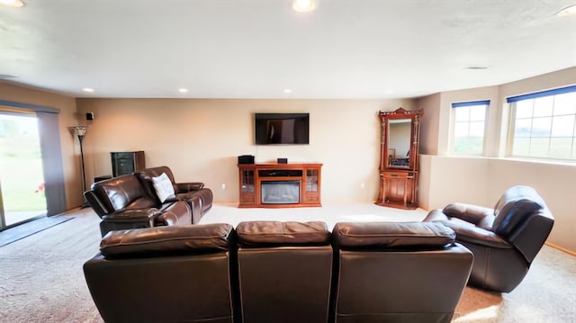 living room with plenty of natural light and light carpet