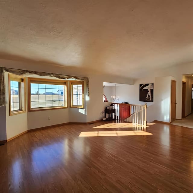 interior space featuring an inviting chandelier and hardwood / wood-style flooring