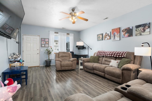 living room featuring wood-type flooring and ceiling fan