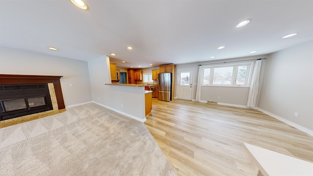 unfurnished living room with light hardwood / wood-style flooring