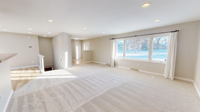 spare room with light carpet