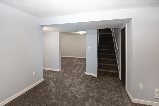 basement featuring dark carpet