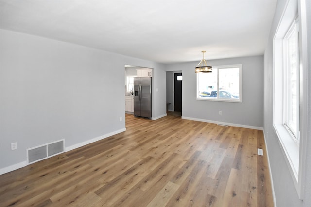 unfurnished living room with light hardwood / wood-style flooring