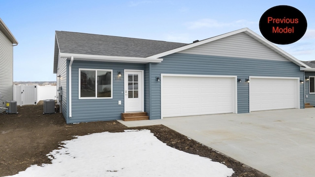 single story home featuring a garage and central AC unit