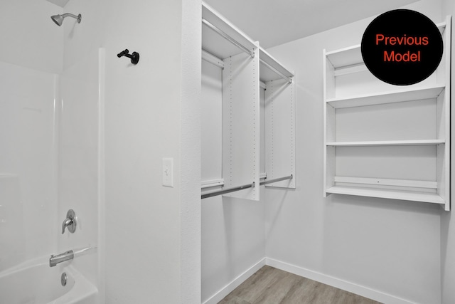 walk in closet with light wood-type flooring