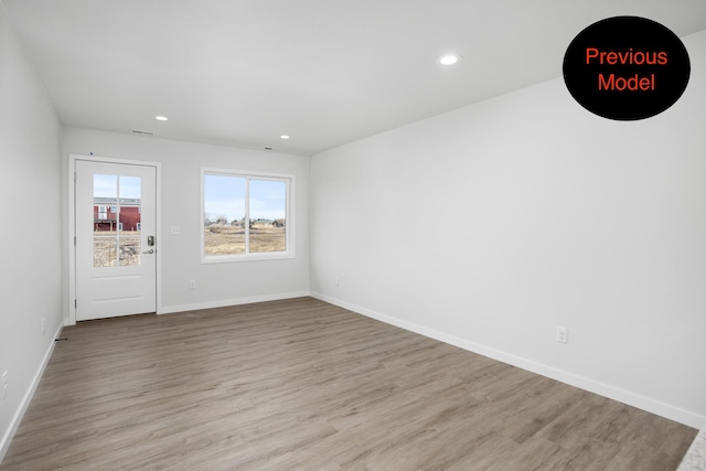 empty room with light hardwood / wood-style floors