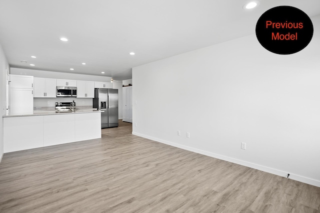 unfurnished living room featuring light hardwood / wood-style flooring