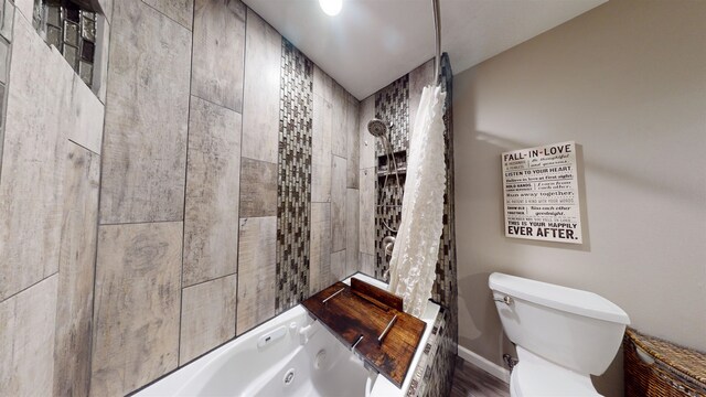 bathroom featuring shower / bathtub combination and toilet