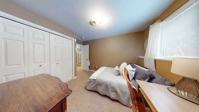 carpeted bedroom featuring a closet