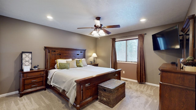 bedroom with ceiling fan and light carpet