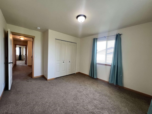 unfurnished bedroom with carpet and a closet