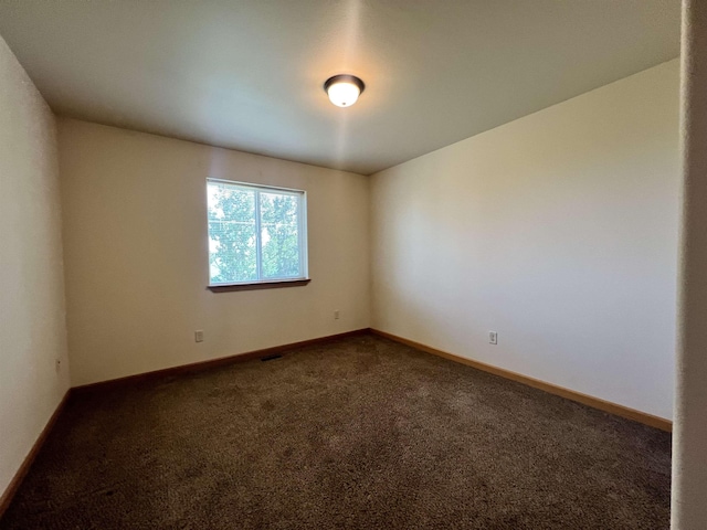 empty room with dark carpet