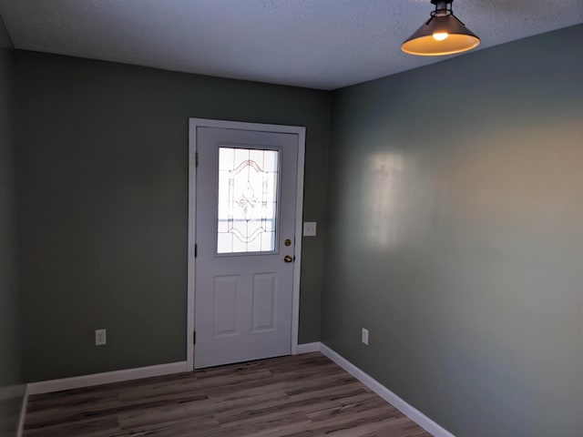 entrance foyer featuring dark hardwood / wood-style flooring and a textured ceiling