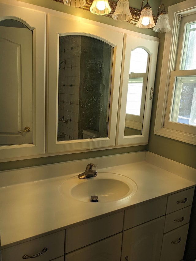 bathroom featuring vanity and toilet