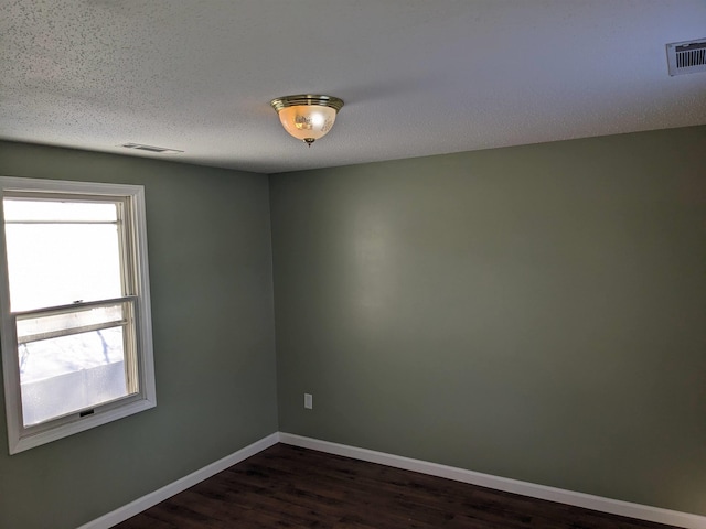 spare room featuring dark hardwood / wood-style floors