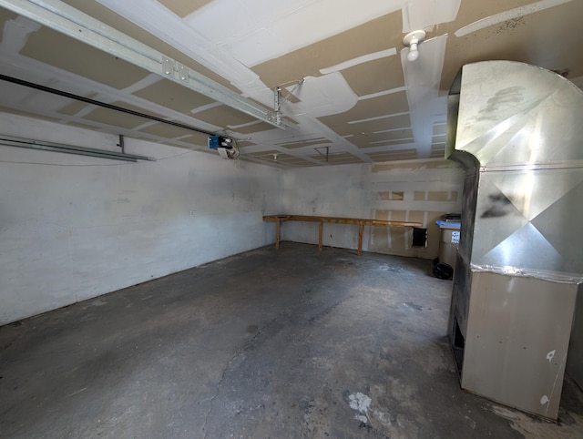 garage with a garage door opener and heating unit