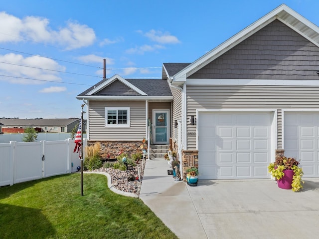 view of front of home with a garage and a front lawn