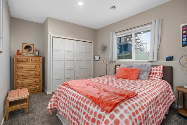 bedroom featuring dark colored carpet and a closet