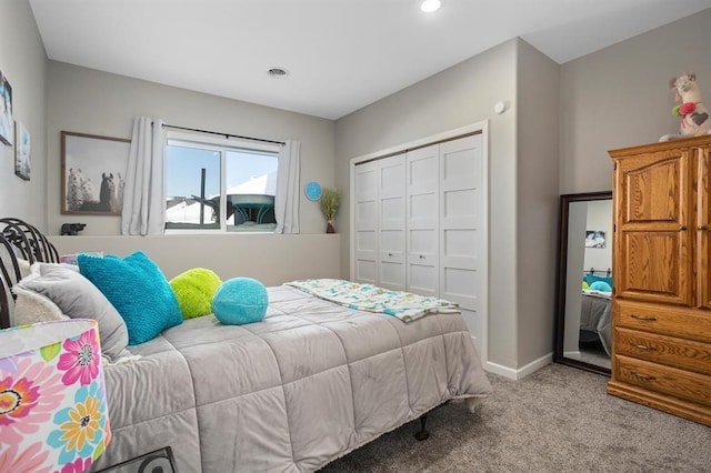 bedroom featuring light carpet and a closet