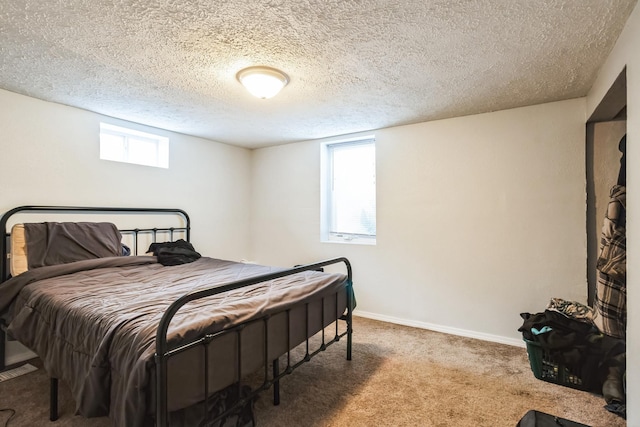 carpeted bedroom featuring a textured ceiling