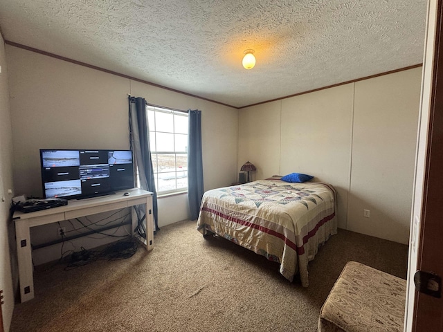 bedroom with crown molding, carpet floors, and a textured ceiling