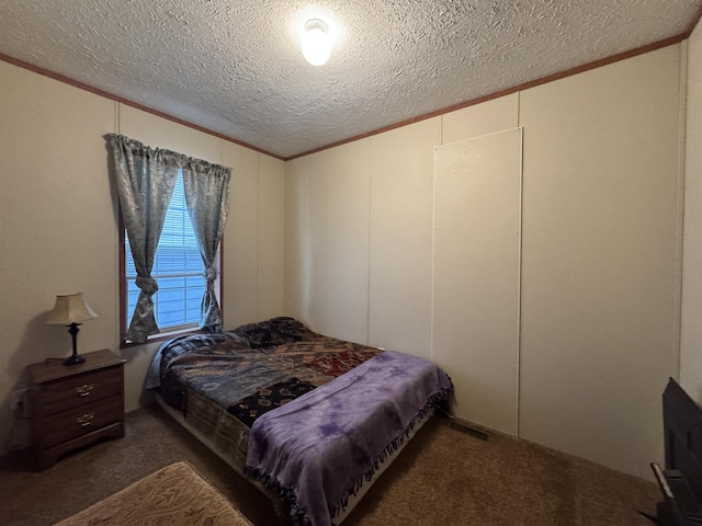 carpeted bedroom featuring crown molding and a textured ceiling