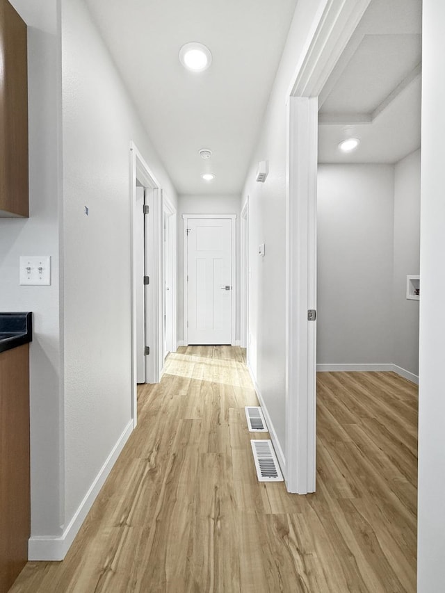 hall with light wood-type flooring