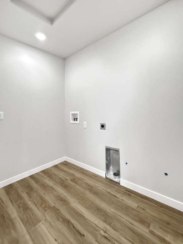 washroom featuring wood-type flooring, washer hookup, and hookup for an electric dryer