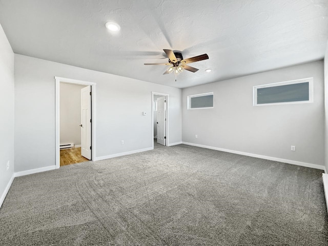 interior space featuring ceiling fan, carpet, a textured ceiling, and a baseboard heating unit