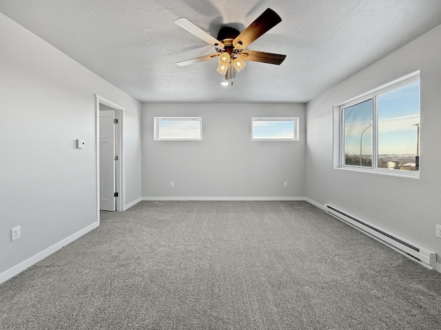 carpeted spare room with baseboard heating, ceiling fan, and a textured ceiling