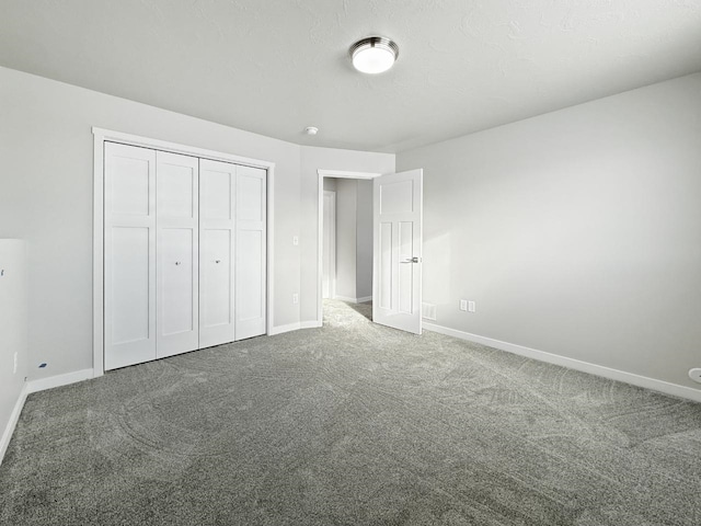 unfurnished bedroom with carpet and a closet