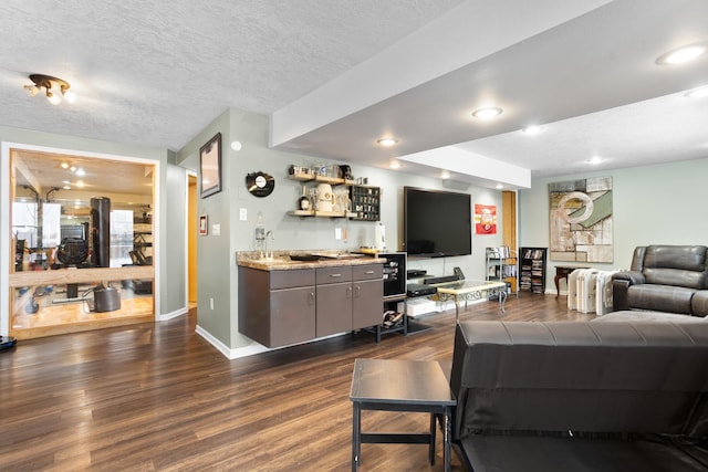 living room featuring a textured ceiling, bar, and dark wood-type flooring