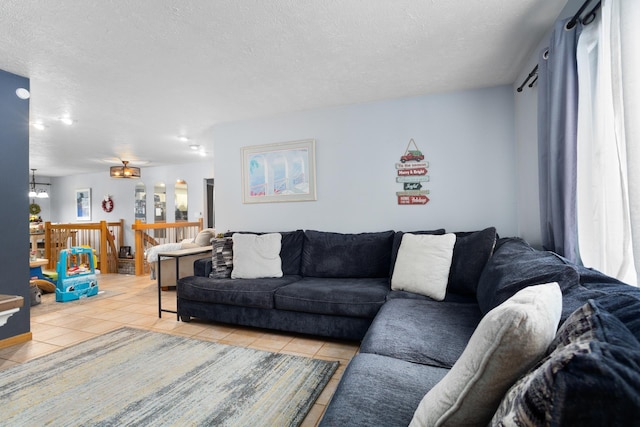 living room featuring light tile patterned flooring and a textured ceiling