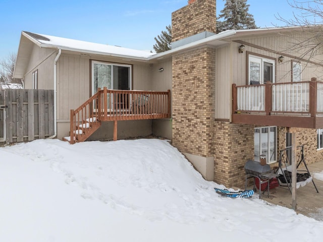 view of snow covered rear of property