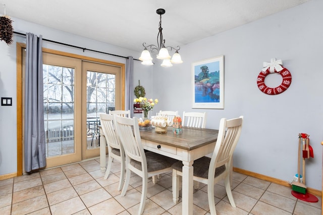 dining space with a notable chandelier and light tile patterned floors