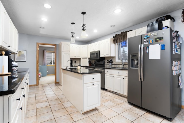 kitchen featuring white cabinets, sink, an island with sink, and stainless steel refrigerator with ice dispenser