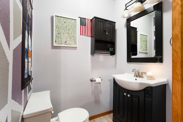 bathroom featuring tile patterned flooring, vanity, and toilet