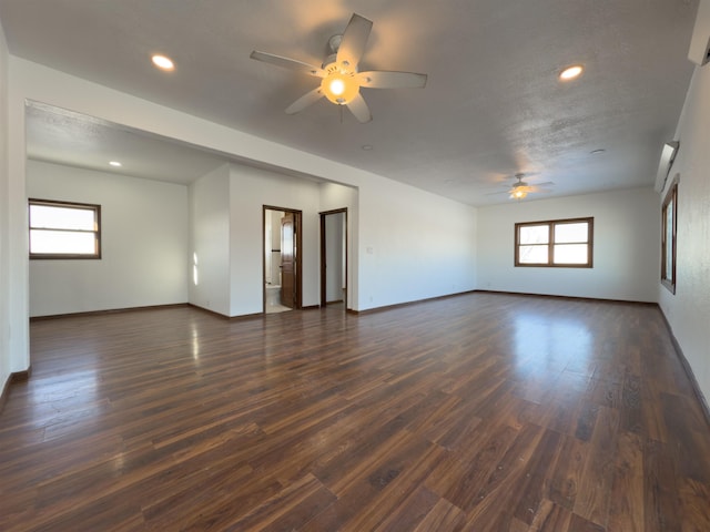 unfurnished room featuring a textured ceiling, dark hardwood / wood-style flooring, and ceiling fan