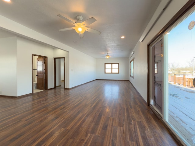 empty room with ceiling fan and dark hardwood / wood-style floors