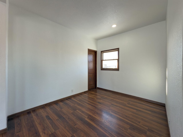 spare room featuring dark hardwood / wood-style flooring