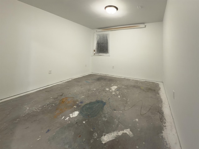 unfurnished room with concrete flooring