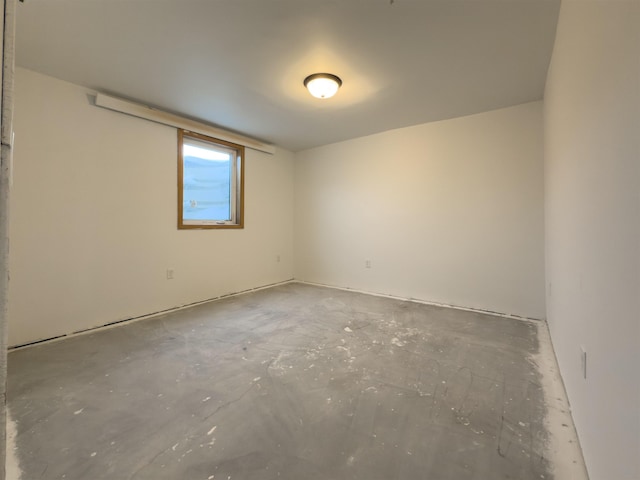 unfurnished room with concrete floors