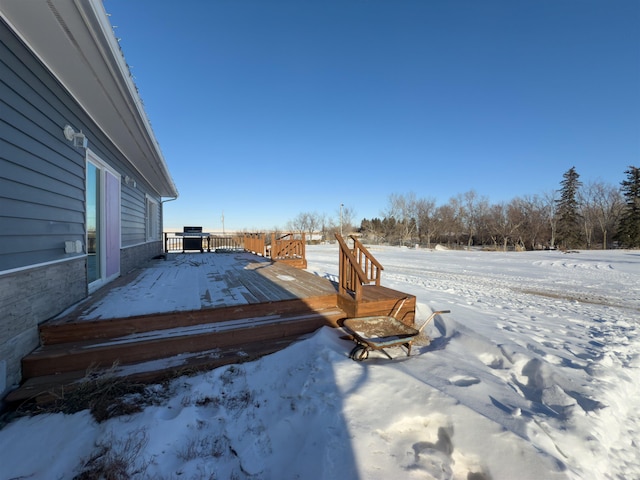 yard covered in snow with a wooden deck