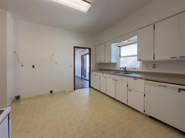 kitchen featuring white dishwasher, white cabinets, and sink