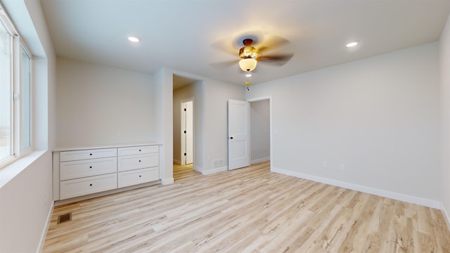 unfurnished bedroom featuring light wood-type flooring and ceiling fan