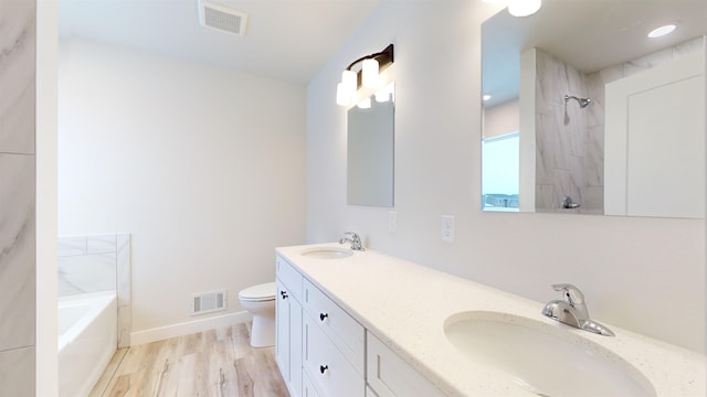 full bathroom featuring plus walk in shower, hardwood / wood-style floors, vanity, and toilet