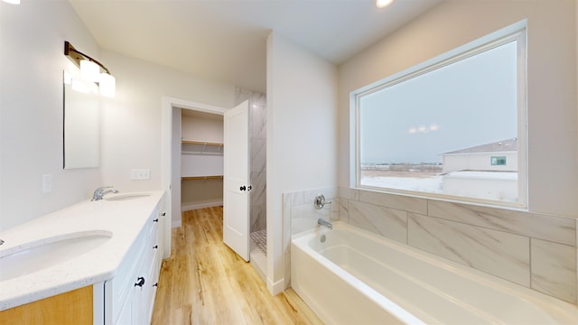 bathroom with vanity, a bath, and hardwood / wood-style flooring